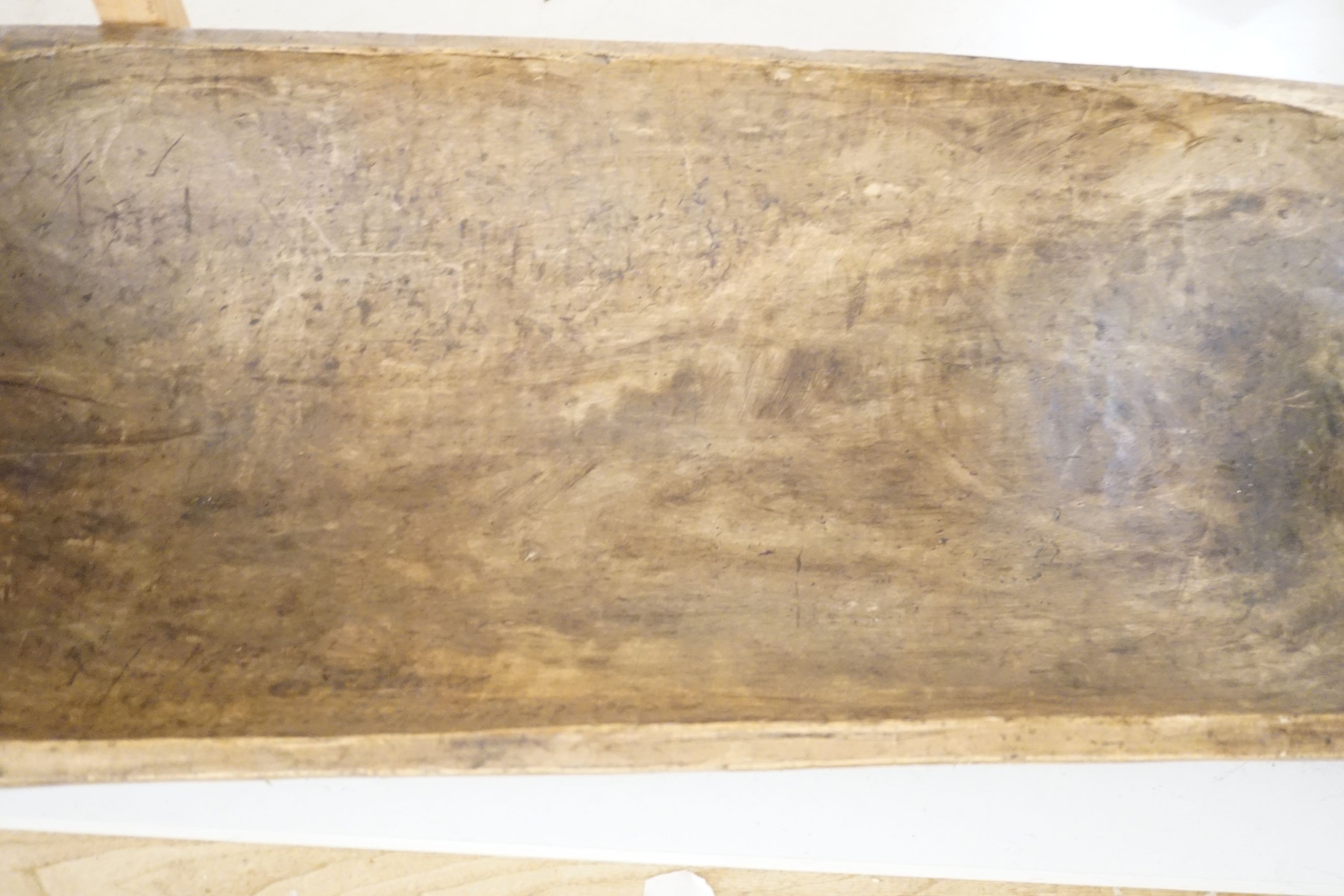 A large 19th century European fruitwood dough trough hewn from a single piece of wood. 132cm x 49cm. *This lot is being sold in aid of the charity Dogs Trust UK with 100% of the hammer price going to the charity